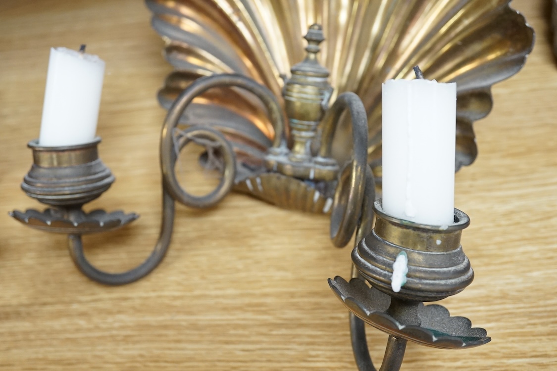 A pair of brass twin branch wall lights with scallop shell backs, 26cm high